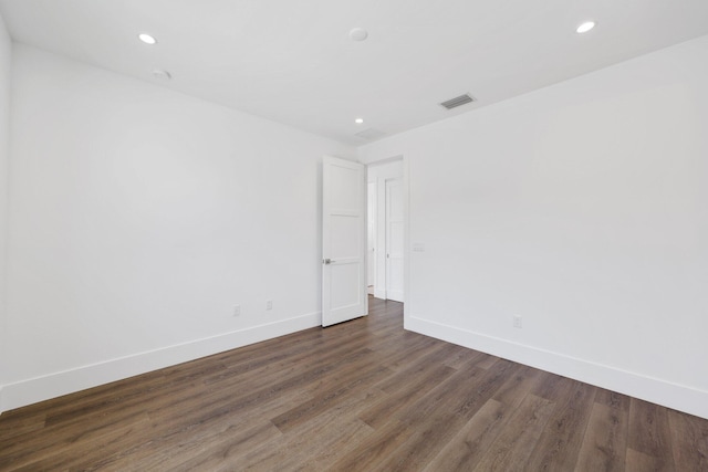 empty room featuring visible vents, baseboards, recessed lighting, and wood finished floors