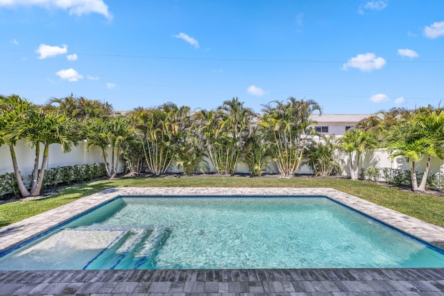 view of swimming pool featuring a yard, a fenced backyard, and a fenced in pool