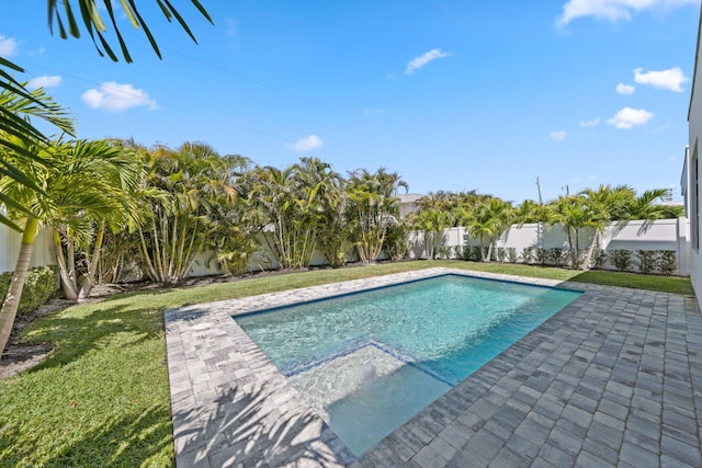 view of swimming pool with a patio area, a fenced in pool, a lawn, and a fenced backyard