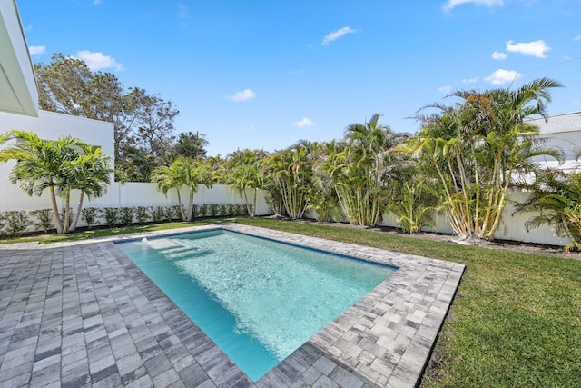 view of pool featuring a yard, a fenced in pool, a patio, and a fenced backyard