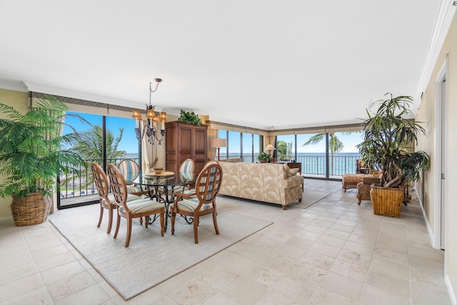 dining room featuring a chandelier, ornamental molding, plenty of natural light, and floor to ceiling windows