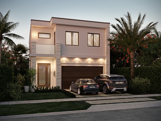 modern home with a garage, driveway, and stucco siding