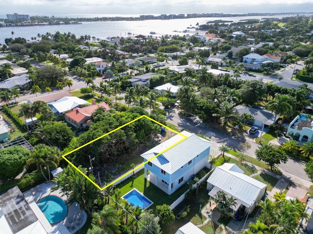 122 Auburn Dr, Lake Worth, FL 33460 - aerial view of residential area with a large body of water, property parcel outlined, and a pool area