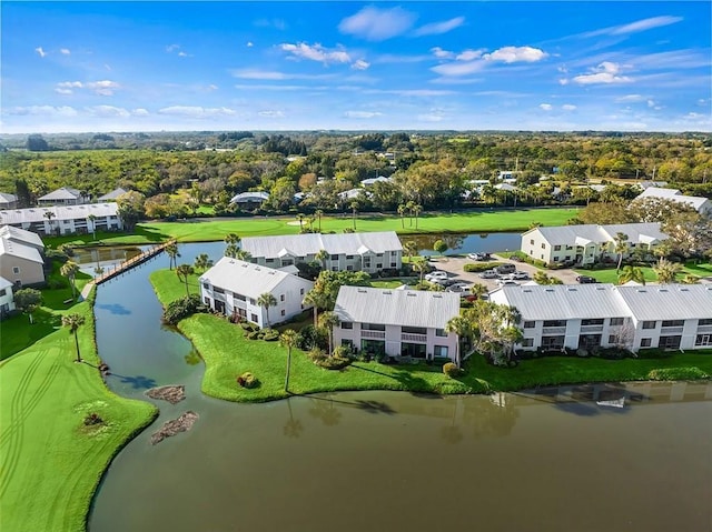 drone / aerial view featuring a water view, a residential view, and golf course view