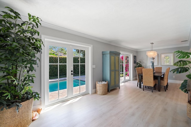 dining area with baseboards, visible vents, french doors, crown molding, and light wood-type flooring