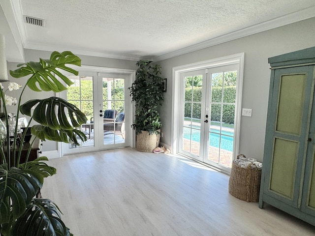 interior space featuring plenty of natural light, french doors, and visible vents