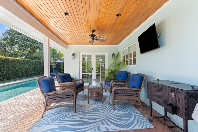 view of patio / terrace featuring an outdoor living space, french doors, a ceiling fan, and a fenced in pool