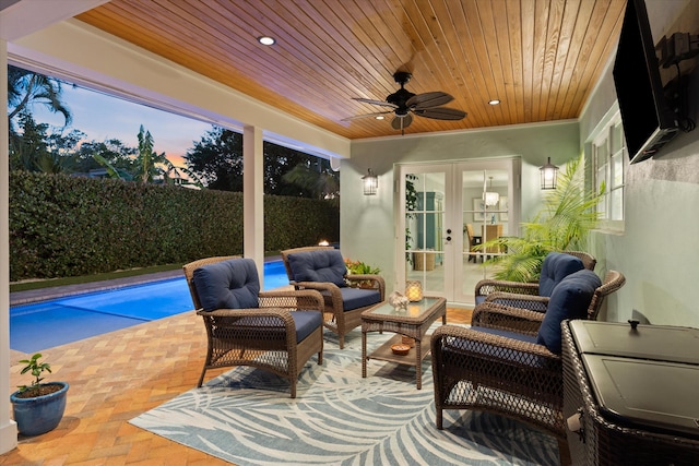 sunroom featuring ceiling fan, french doors, and wooden ceiling