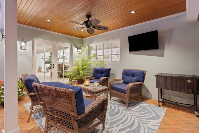 view of patio featuring a ceiling fan, an outdoor living space, and french doors