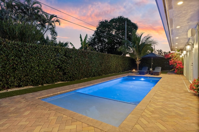 view of swimming pool featuring a fenced in pool, a patio, and a fenced backyard