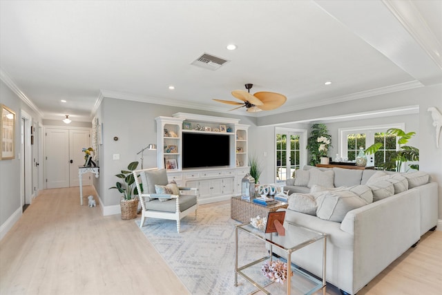 living room with visible vents, light wood-style floors, ceiling fan, and crown molding