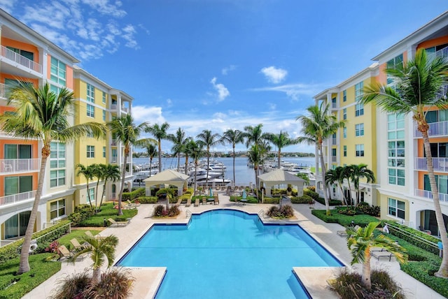 community pool with a water view and a patio