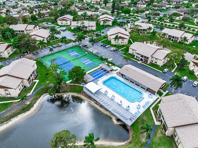 drone / aerial view with a residential view and a water view