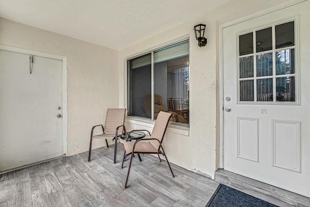 entrance to property featuring stucco siding