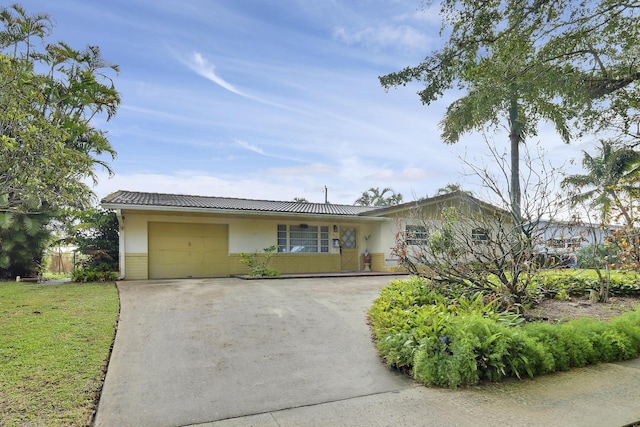 single story home with a garage, driveway, and a tile roof