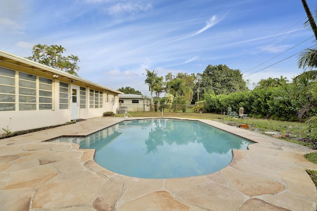 view of swimming pool with a fenced in pool and a patio