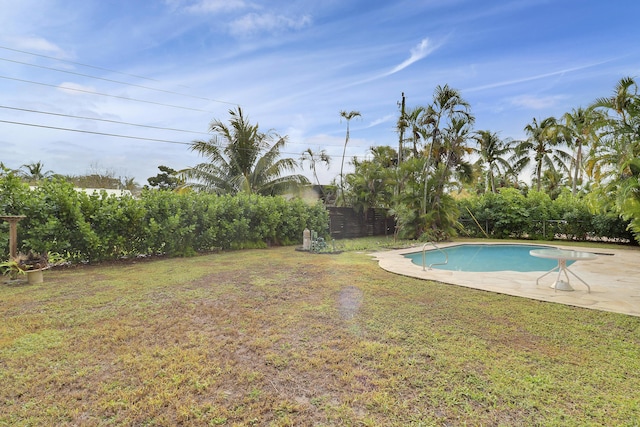 pool with a yard, a patio, and fence