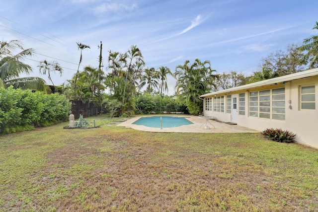 pool with a lawn and a patio