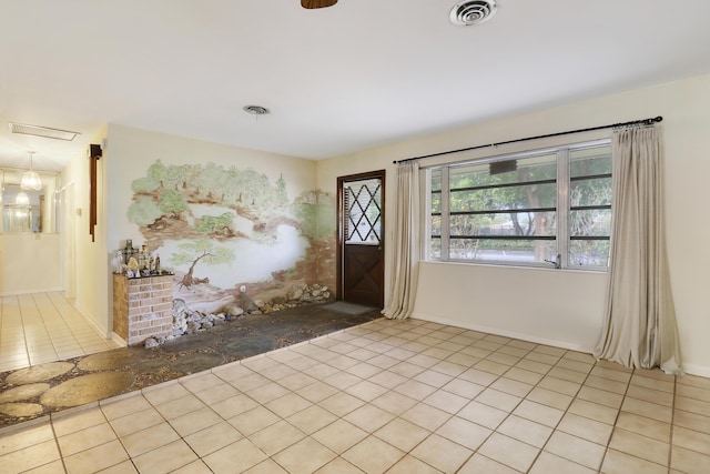 entryway featuring light tile patterned floors, baseboards, and visible vents