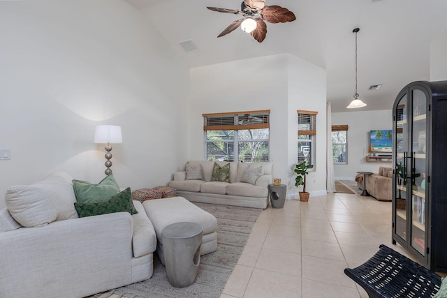 living room featuring visible vents, high vaulted ceiling, a ceiling fan, light tile patterned flooring, and baseboards