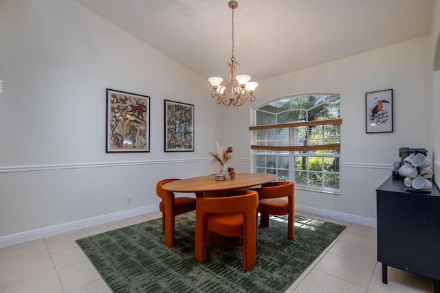 dining area with light tile patterned floors, baseboards, lofted ceiling, and an inviting chandelier