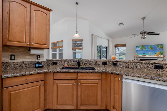 kitchen with stainless steel dishwasher, dark stone countertops, and visible vents