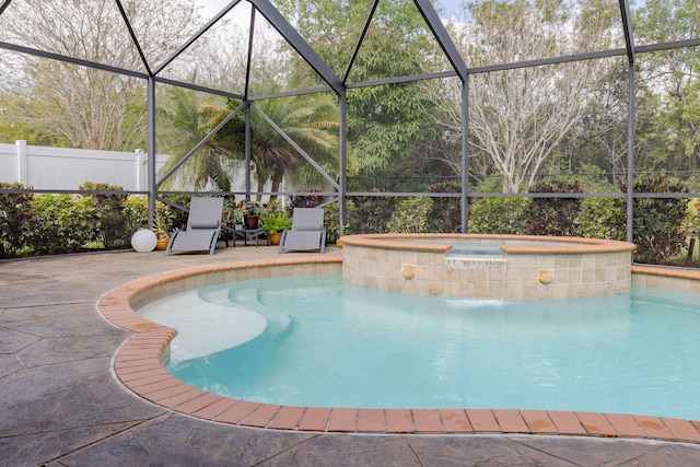 view of swimming pool featuring an in ground hot tub, a patio area, fence, and a lanai