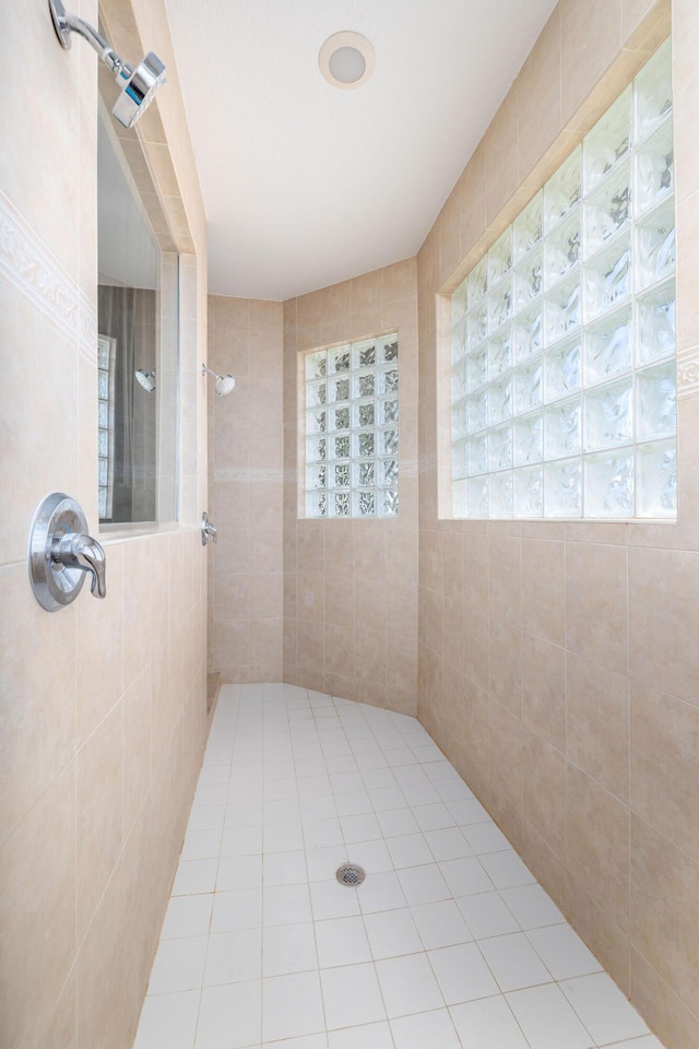 full bath with a tile shower