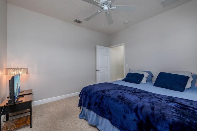 carpeted bedroom with visible vents, a ceiling fan, and baseboards