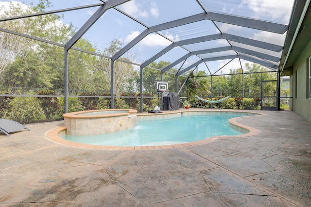 view of pool featuring a lanai, a pool with connected hot tub, and a patio