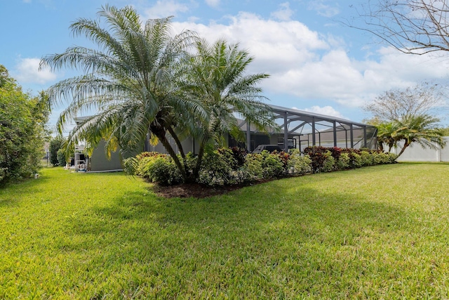 view of yard with a lanai and fence