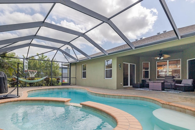 view of swimming pool with a patio area, glass enclosure, a pool with connected hot tub, and ceiling fan