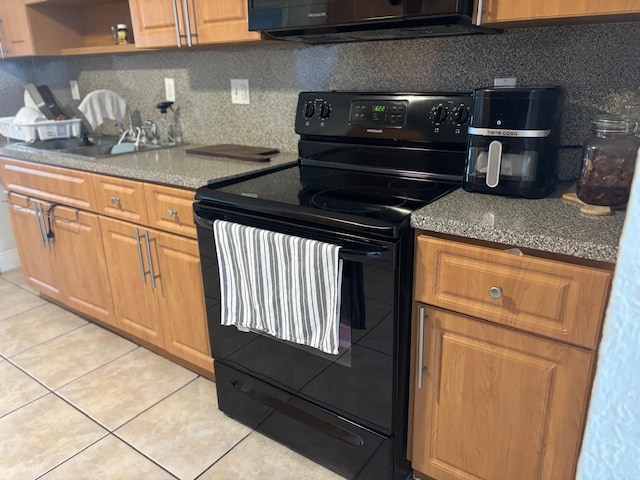 7430 Atlanta St, Hollywood, FL 33024 - kitchen with light tile patterned floors, electric range, a sink, tasteful backsplash, and brown cabinetry