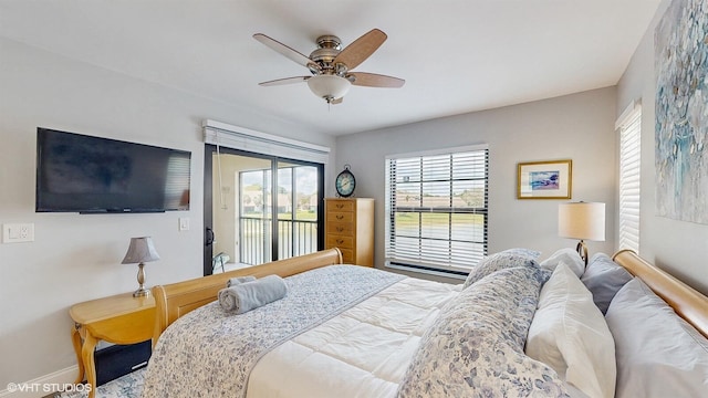 bedroom featuring access to outside, baseboards, and ceiling fan