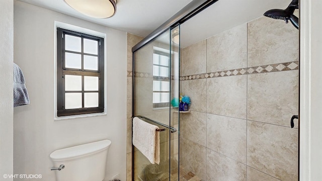 full bathroom featuring toilet and a stall shower