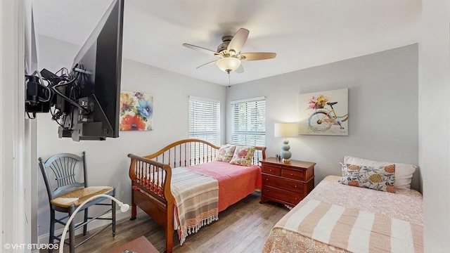 bedroom with a ceiling fan and dark wood-style flooring