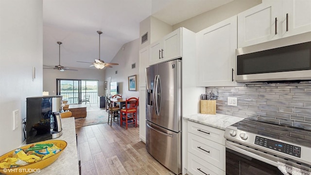 kitchen featuring stainless steel appliances, visible vents, backsplash, light wood-style floors, and white cabinets