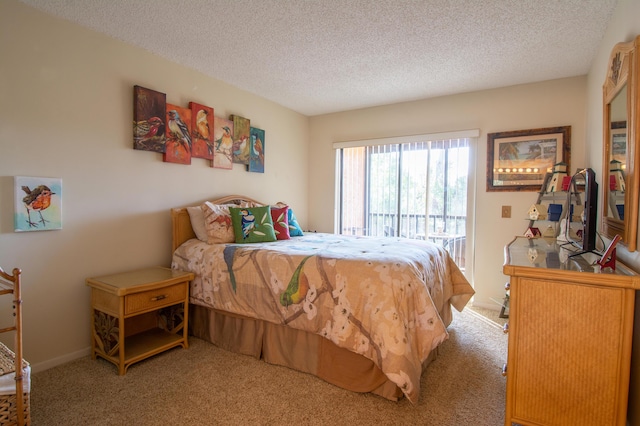 bedroom featuring a textured ceiling, carpet floors, and access to outside