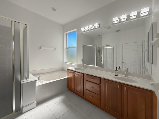 bathroom with a sink, double vanity, tile patterned flooring, and a garden tub