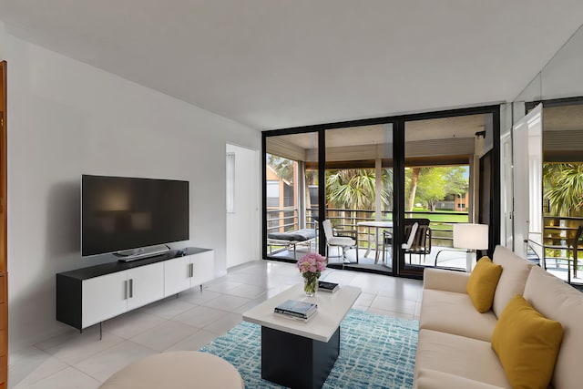 living area with a wealth of natural light, floor to ceiling windows, and light tile patterned floors