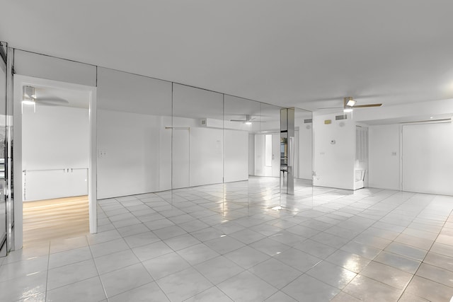 interior space featuring light tile patterned floors and ceiling fan