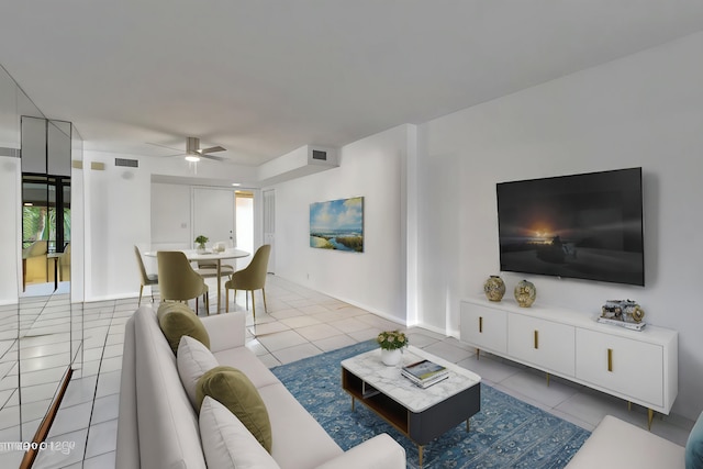 living room with tile patterned floors, visible vents, baseboards, and ceiling fan