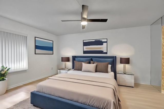 bedroom with wood finished floors, baseboards, and ceiling fan