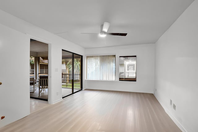 spare room with light wood-style floors, baseboards, and ceiling fan