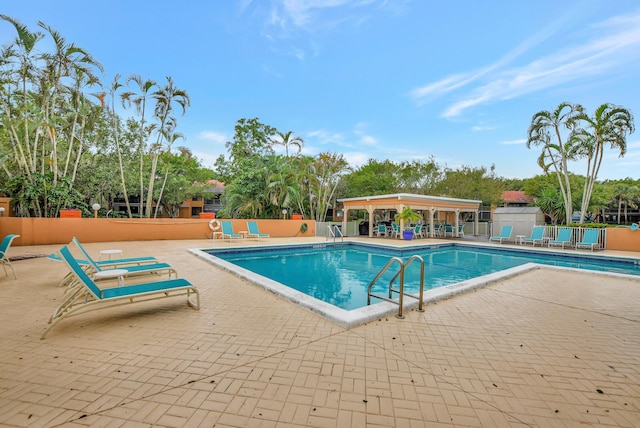 pool featuring a patio area and fence