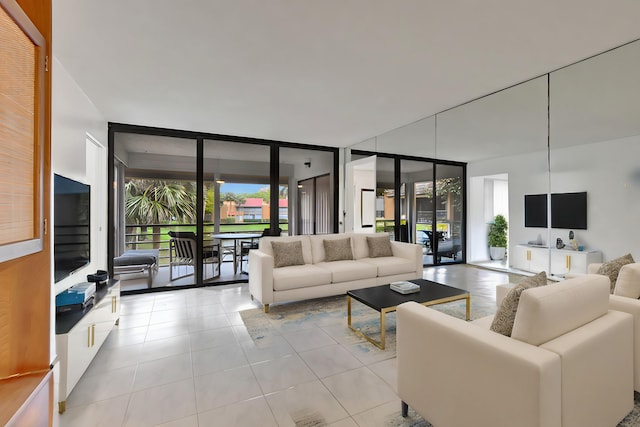 living room with tile patterned flooring, floor to ceiling windows, and a healthy amount of sunlight