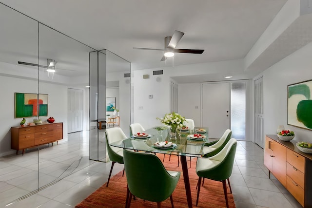 dining room featuring light tile patterned floors, visible vents, and ceiling fan