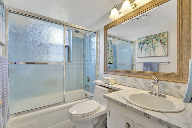 full bathroom with toilet, shower / bath combination with glass door, decorative backsplash, and vanity