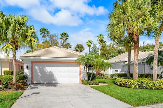 ranch-style home with an attached garage, a tiled roof, concrete driveway, stucco siding, and a front yard