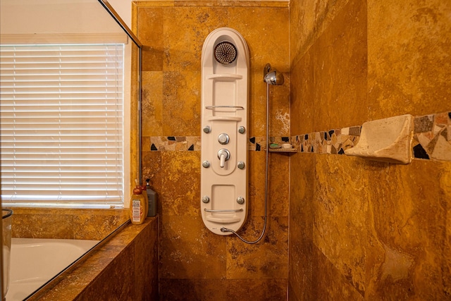 details featuring a tile shower and a bath